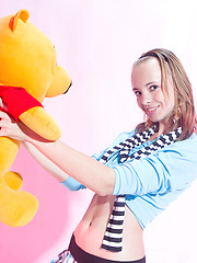 Wonderful teen beauty in striped gaiters with a teddy bear undressing and spreading legs