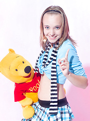 Wonderful teen beauty in striped gaiters with a teddy bear undressing and spreading legs