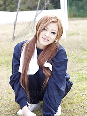 Long haired An Umemiya poses outdoor on field