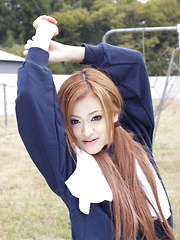 Long haired An Umemiya poses outdoor on field